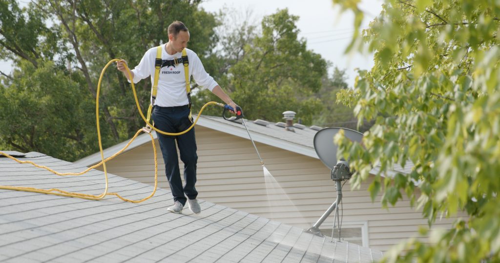 Roof specialist treating shingles